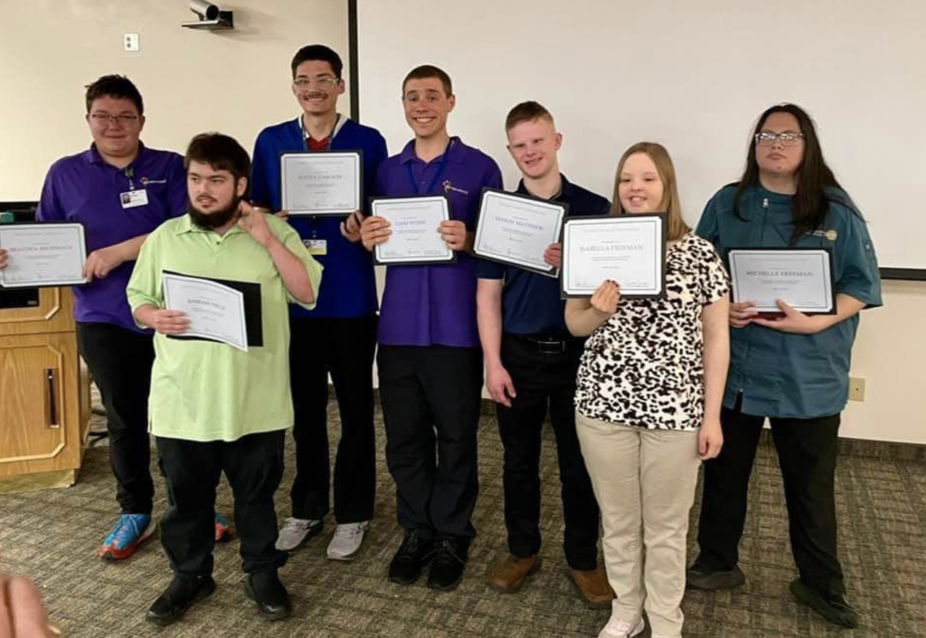 Group of Project SEARCH 2024 graduates standing holding their certificates